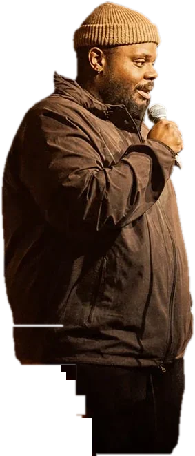 A comedian at the mic in a brick-walled comedy club